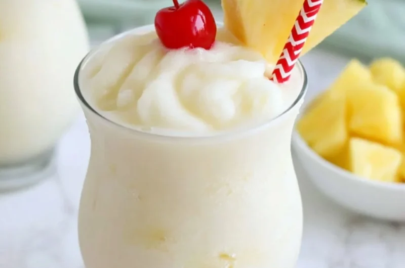 Non-alcoholic virgin piña colada served in a coconut with tropical fruits