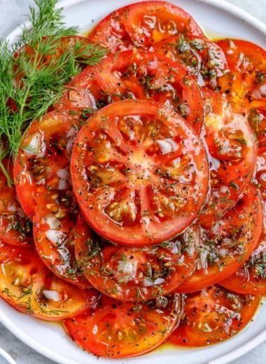Fresh tomato salad with herbs and spices served in a cozy setting.