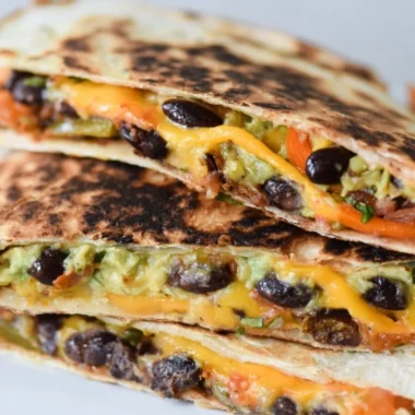 Cozy black bean veggie quesadilla with colorful vegetables and melted cheese