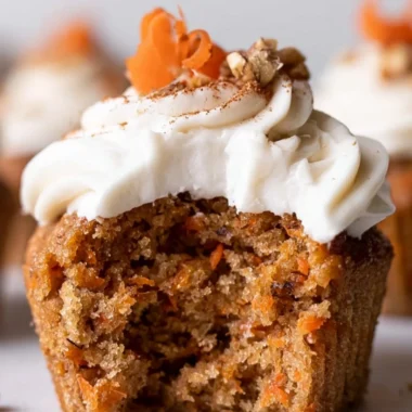 Cozy carrot cake cupcakes with cream cheese frosting on a wooden table