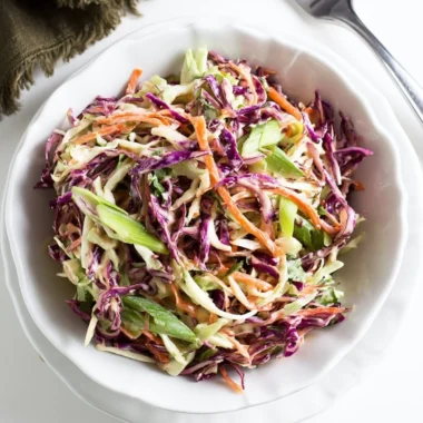 Cozy coleslaw served as a side for pulled pork sandwiches