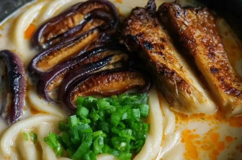 Cozy miso udon noodle soup topped with teriyaki mushrooms in a delicious broth.