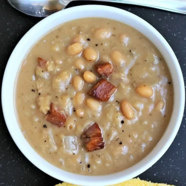 Creamy Great Northern Beans with Ham in a rustic bowl