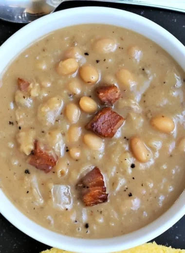 Creamy Great Northern Beans with Ham in a rustic bowl