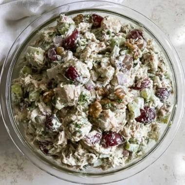 Healthy chicken salad without mayo served in a bowl with fresh vegetables.
