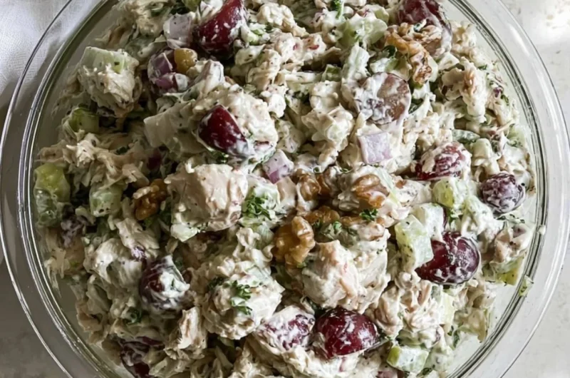 Healthy chicken salad without mayo served in a bowl with fresh vegetables.