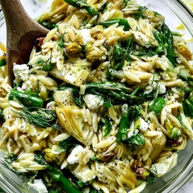 Orzo salad with feta cheese and asparagus served in a bowl