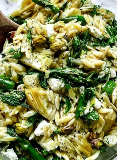 Orzo salad with feta cheese and asparagus served in a bowl