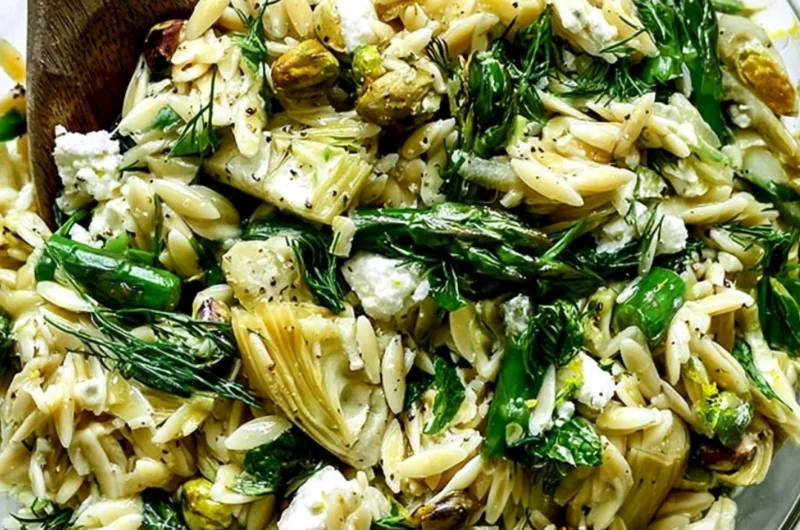 Orzo salad with feta cheese and asparagus served in a bowl