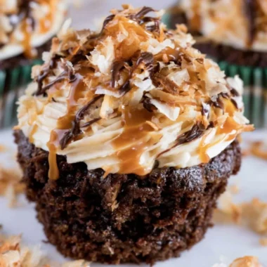Delicious Samoas Cupcakes topped with caramel and toasted coconut.
